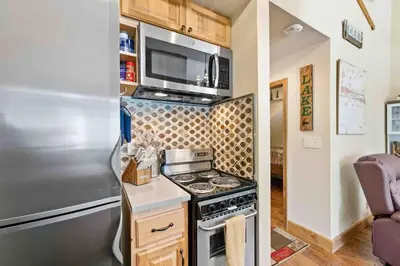 a kitchen with a stove and a microwave at TahoeCozy with Pool Hot Tub and Near Northstar in Tahoe Vista