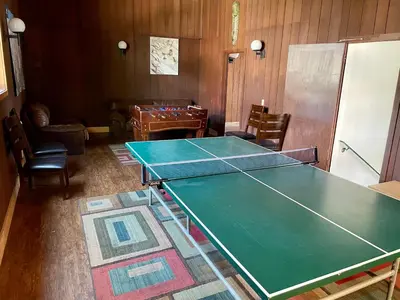 a room with a ping pong table and chairs at Fireside Condo at the Village - Remodeled in Mammoth Lakes