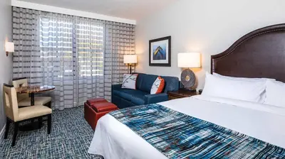 a hotel room with a bed and a blue couch at Marriott Timber Lodge 2BR Apartment with Resort Access in South Lake Tahoe