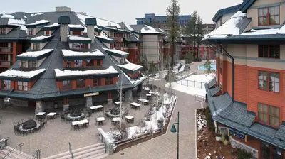 a large building with a courtyard with tables and chairs at Marriott Timber Lodge 3BR Apartment with Resort Access in South Lake Tahoe