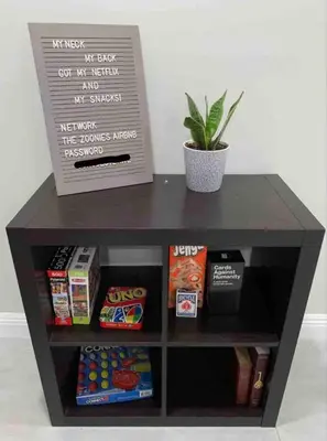 a black table with a box of food and a plant at Rustic Retreat 3 bd/2 bth - Large Family Game Area in Fresno