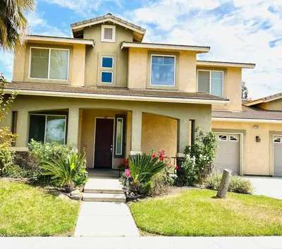 a large house with a driveway in front of it at la paz private room with jacuzi in Fresno