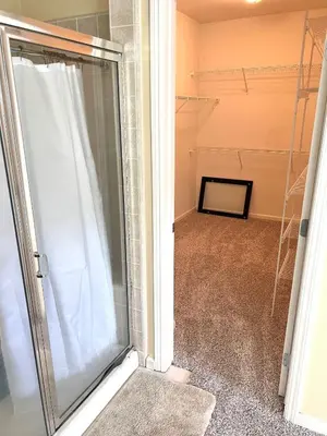 a walk in shower in a room with a glass door at la paz private room with jacuzi in Fresno
