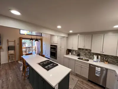a kitchen with white cabinets and a white counter top at Cozy Mtn Condo - Hot Tub - Walk to Canyon Lodge in Mammoth Lakes