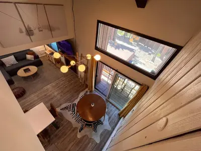 an overhead view of a living room with a wooden table at Cozy Mtn Condo - Hot Tub - Walk to Canyon Lodge in Mammoth Lakes
