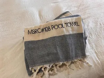 a bag with the wordsmetro polo polo tote on a bed at Cozy Mtn Condo - Hot Tub - Walk to Canyon Lodge in Mammoth Lakes