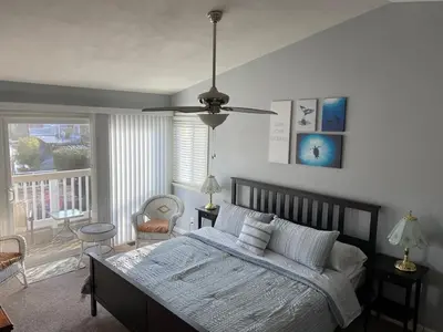 a bedroom with a bed and a ceiling fan at Waterfront Sleeps 6 near Marina with Hot Tub in Discovery Bay