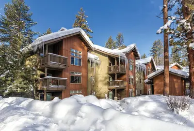 an apartment building with snow in front of it at Wyndham South Shore 2BR Apartment with Resort Access in Zephyr Cove