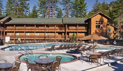 a resort with a swimming pool with tables and chairs at Wyndham South Shore 2BR Apartment with Resort Access in Zephyr Cove