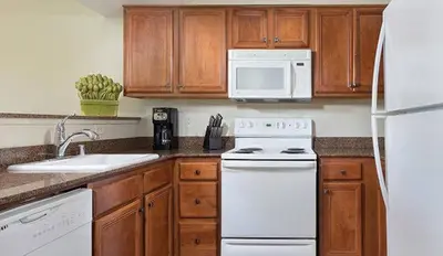 a kitchen with white appliances and wooden cabinets at Wyndham South Shore 3BR Apartment with Resort Access in Zephyr Cove