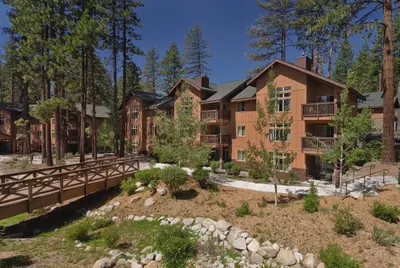 an exterior view of a large apartment building with a bridge at Wyndham South Shore 3BR Apartment with Resort Access in Zephyr Cove