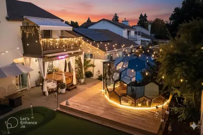 a house with a deck at night with lights at Elegant Retreat- Sleep 10-Boho Dome Lounge-Hot Tub-Games-Golf-Serene Getaway in Sacramento