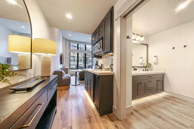 a large kitchen with a sink and a mirror at Catamount Lodge 101 by East West Hospitality in Truckee