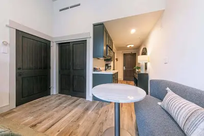 a living room with a couch and a table at Catamount Lodge 101A by East West Hospitality in Truckee