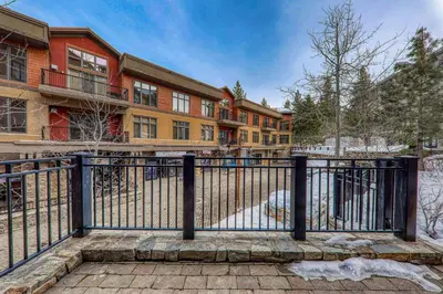 an apartment building with a gate in front of it at Catamount Lodge 101B by East West Hospitality in Truckee