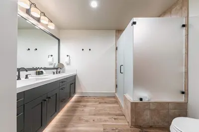 a bathroom with a shower and a sink and a toilet at Catamount Lodge 101B by East West Hospitality in Truckee