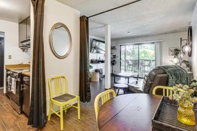 a kitchen and living room with a table and chairs at Walk to Virginia Lake Reno Condo with Balcony! in Reno