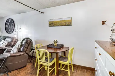 a kitchen and dining room with a table and chairs at Walk to Virginia Lake Reno Condo with Balcony! in Reno