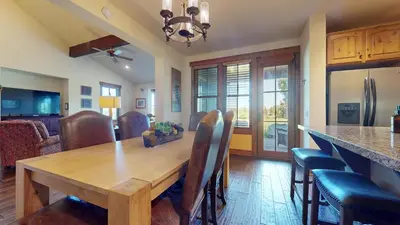 a kitchen and dining room with a wooden table and chairs at Snowcreek VI The Lodges #1197 condo in Mammoth Lakes