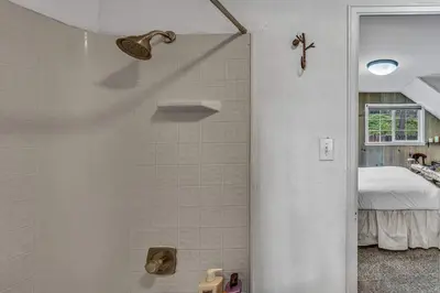 a bathroom with a shower and a bed at Tahoe City Gem Pet Friendly Yard Walk to Beach in Tahoe City