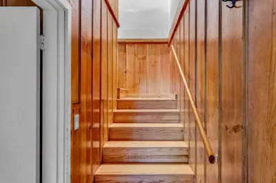 a staircase in a house with wooden walls at Tahoe City Gem Pet Friendly Yard Walk to Beach in Tahoe City