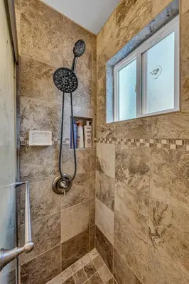 a shower with a shower head in a bathroom at Tahoe City Gem Pet Friendly Yard Walk to Beach in Tahoe City