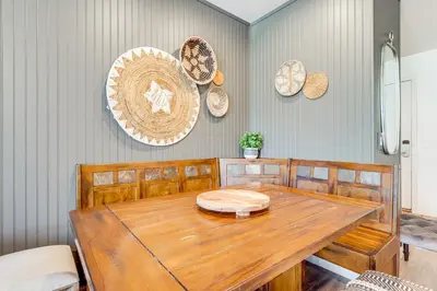 a dining room with a wooden table and plates on the wall at Stroll to The Village Year-Round Family Getaway in Mammoth Lakes