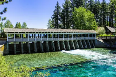 a bridge over a river with a building at Unit 18B at Granlibakken in Tahoe City
