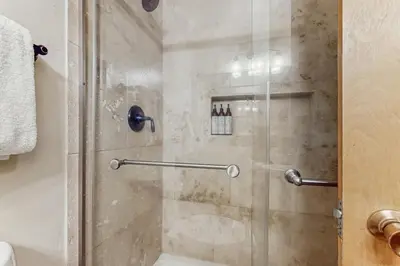 a shower with a glass door in a bathroom at Unit 18B at Granlibakken in Tahoe City