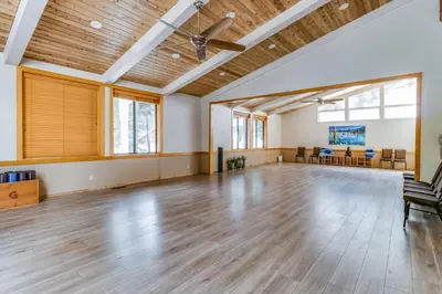 an empty ballroom with a wooden floor and a ceiling at Unit 18B at Granlibakken in Tahoe City