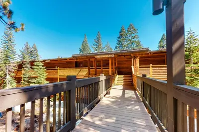 a wooden walkway leading to a log cabin at Unit 18B at Granlibakken in Tahoe City