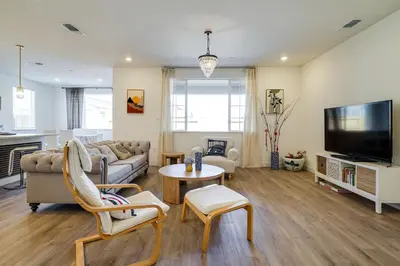 a living room with a couch and a table at 4 Mi to San Joaquin River Manteca Home with Patio! in Manteca