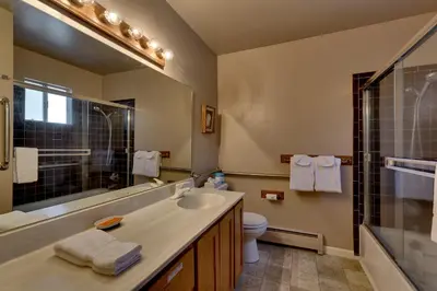 a bathroom with a sink and a toilet and a mirror at Heavenly Valley Townhouses in South Lake Tahoe