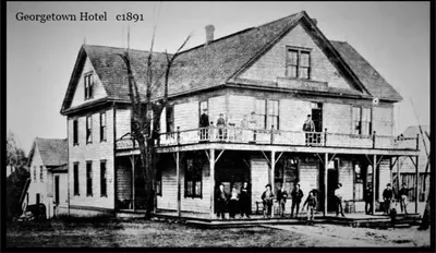 a black and white photo of a large house at Georgetown Hotel and Saloon in Georgetown