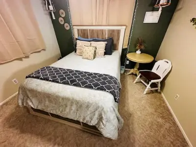 a bedroom with a bed and a table and a chair at Family Fun-Dogs ok-Bass lake-Yosemite-Sleeps 8 in Oakhurst
