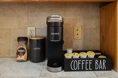 a coffee maker next to a box of cupcakes at Yosemite+5BR+Views+Hot Tub+Pets in Coarsegold