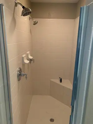 a bathroom with a shower with a toilet and a sink at Furnished five bedroom and gated community in Patterson