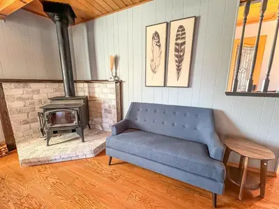 a living room with a couch and a stove at On Golf Course, Family&Pet Friendly Yosemite Basecamp in Groveland