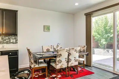 a kitchen and dining room with a table and chairs at Walk to Parks Mountain House Retreat with Patio! in Tracy