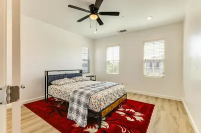 a bedroom with a bed and a ceiling fan at Walk to Parks Mountain House Retreat with Patio! in Tracy