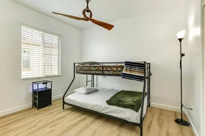 a bedroom with a bunk bed and a ceiling fan at Walk to Parks Mountain House Retreat with Patio! in Tracy