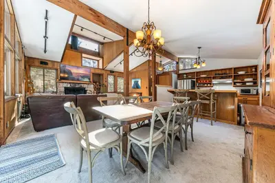 a kitchen and dining room with a table and chairs at Front and Center at Palisades by Tahoe Getaways - 3BR, Walk to Palisades! in Olympic Valley