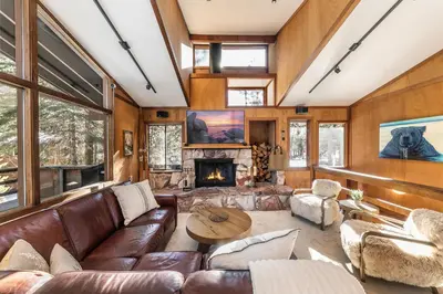 a living room with leather furniture and a fireplace at Front and Center at Palisades by Tahoe Getaways - 3BR, Walk to Palisades! in Olympic Valley