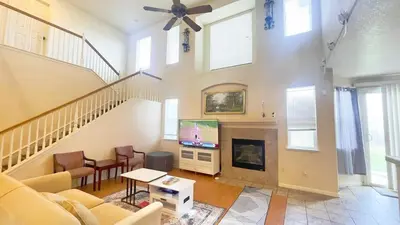 a living room with a couch and a tv and a fireplace at New - Spacious, Comfortable 5 Beds 3 Baths House in Elk Grove