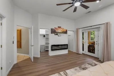 a living room with a ceiling fan and white walls at Stylish 6 Bdr home, GameRoom, near Lake | Yosemite in Groveland