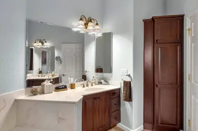 a bathroom with a large sink and a large mirror at Stylish 6 Bdr home, GameRoom, near Lake | Yosemite in Groveland