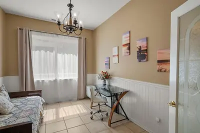 a bedroom with a table and a bed and a window at Yosemite-bound, Fun at the lake, Spacious & stylish 6 Bdr home with game room in Groveland