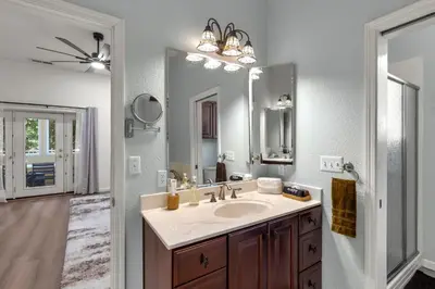 a bathroom with a sink and a large mirror at Yosemite-bound, Fun at the lake, Spacious & stylish 6 Bdr home with game room in Groveland