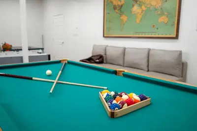 a pool table with a box of balls on it at Yosemite-bound, Fun at the lake, Spacious & stylish 6 Bdr home with game room in Groveland