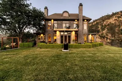a large house with a grassy yard in front of it at Serene Millerton Lake Villa w/ Panoramic Lake View